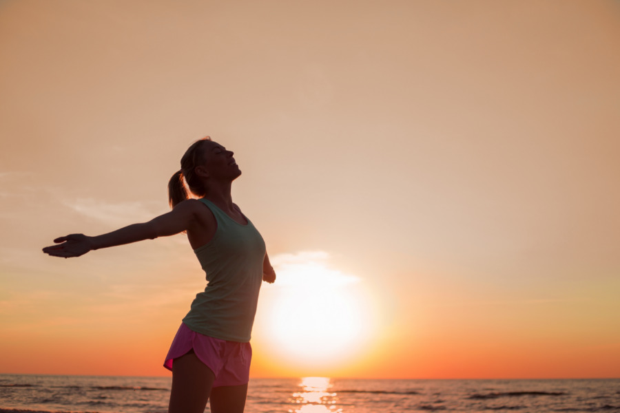 Exercise Yoga on the beach at sunset KOSI Wellness